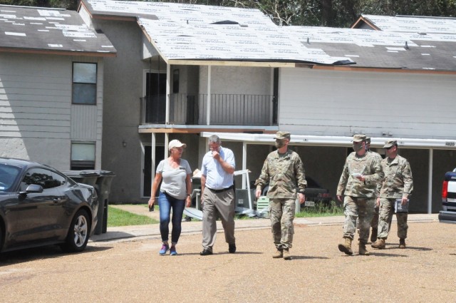 Brig. Gen. Patrick D. Frank, Joint Readiness Training Center and Fort Polk commanding general, (center) leads his team on the neighborhood walking tour Sept. 2 through a cul de sac in Palmetto Terrace that had homes with considerable roof damage.