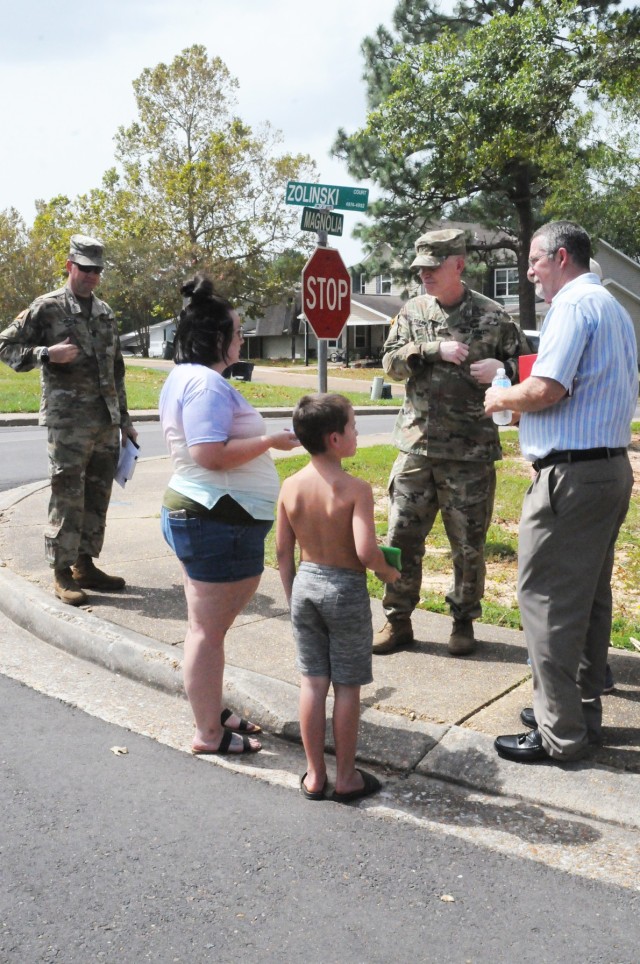 Brig. Gen. Patrick D. Frank, Joint Readiness Training Center and Fort Polk commanding general, (center) and members of his team stop to talk to Heather King, a Fort Polk spouse, and her son, Liam, 7, about hurricane recovery progress during the...