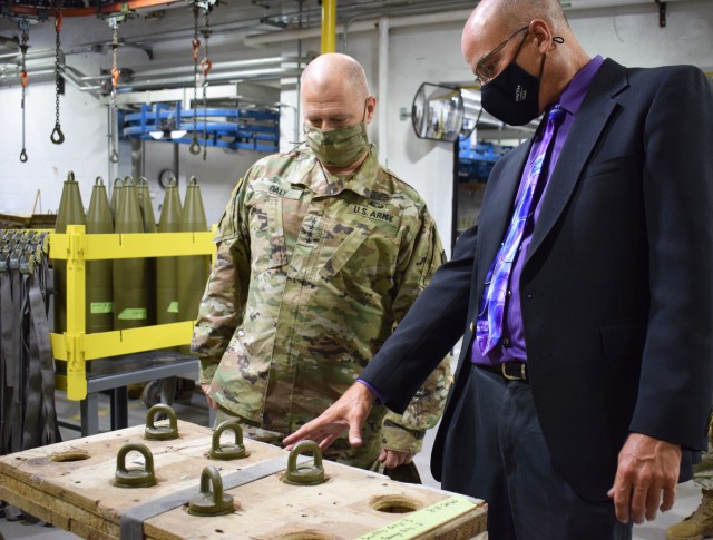 A Crane Army Ammunition Activity employee discusses with Gen. Ed Daly, the commanding general of U.S. Army Materiel Command, during a visit Sept. 4 how upgrades at Crane Army’s flagship flexible manufacturing complex allow CAAA to produce...