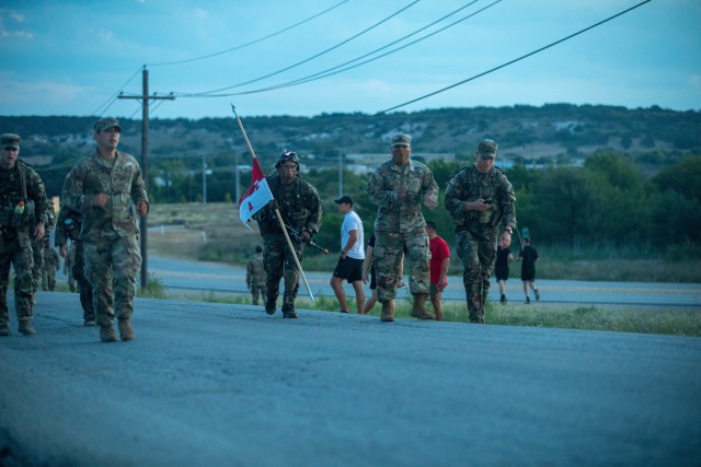 GREYWOLF Trooper Sgt. Mark Lopez, 2nd Battalion, 7th Cavalry Regiment, 3rd Armored Brigade Combat Team, 1st Cavalry Division completes a culminating 12-mile ruck march while carrying his unit guide-on for the final event of the coveted Expert Soldier Badge (ESB) and Expert Infantry Badge (EIB) qualification, Fort Hood, Texas, August 28, 2020. The ESB and EIB qualification tests the Soldiers knowledge on basic Infantry and basic Soldier skills. If they qualify, they will be awarded the title “expert” in their field. (U.S. Army photo by Sgt. Calab Franklin)
