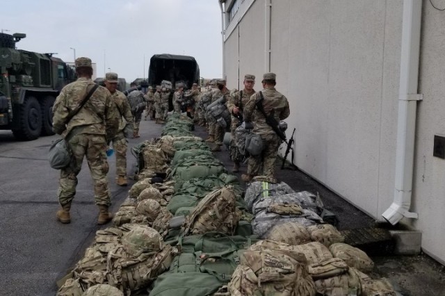 Soldiers load their bags onto vehicles prior to starting a 160-mile convoy from Camp Humphreys to Camp Carroll during a 563rd Medical Logistics Company field training exercise, held Aug. 15-22 in South Korea. (U.S. Army photo by Staff Sgt. Erik V. Freeman)