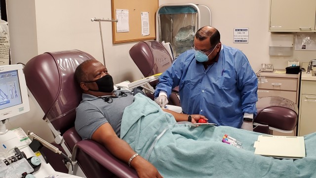 Richard Rangel, medical laboratory technician, prepares Thefety Tibbs, who was among the first donors of convalescent plasma, for his first convalescent plasma donation in June 2020 at the Akeroyd Blood Donor Center on Joint Base San Antonio Fort Sam Houston. The Armed Services Blood Program is accepting convalescent plasma donations at the Akeroyd center for use by Brooke Army Medical Center as a potential treatment for COVID-19. (U.S. Army courtesy photo)