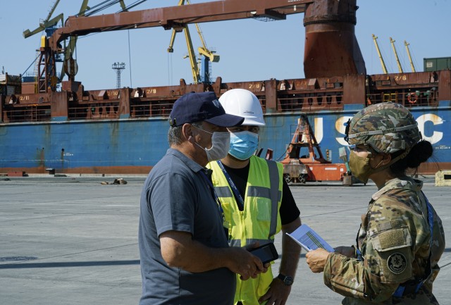 U.S. Army Capt. Meghan Taitano, right, assigned to the 4th Squadron, 2d Cavalry Regiment, speaks with contractors during port operations for the Noble Partner 20 exercise in Poti, Georgia, Sept. 4, 2020. Exercise Noble Partner is designed to enhance regional partnerships and increase U.S. force readiness and interoperability in a realistic, multinational training environment. The exercise allows participants to conduct situational training exercises, live-fire exercises and combined mechanized maneuvers. The 4th Squadron, 2d Cavalry Regiment (Sabers) will lead the exercise for 2d Cavalry Regiment.