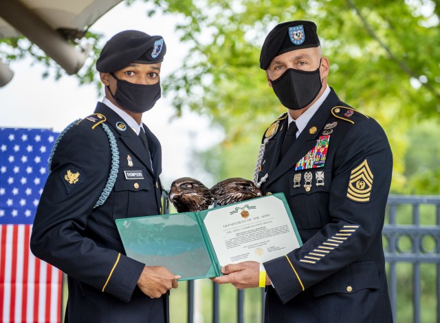 Spc. Stanley T. Thompson (left), a U.S. Army Reserve indirect fire infantryman from Sacramento, California, representing the 95th Training Division (Initial Entry Training), 108th Training Command (Initial Entry Training), receives the Army Commendation Medal and a trophy from Command Sgt. Maj. Andrew Lombardo, U.S. Army Reserve command sergeant major, for winning Soldier of the Year in the 2020 U.S. Army Reserve Best Warrior Competition at Fort McCoy, Wisconsin, Sept. 10. More than 40 Soldiers from across the nation traveled to compete in this year’s Best Warrior, hosted from Sept. 4-10, 2020. The 2020 BWC is an annual competition that brings in the best Soldiers across the U.S. Army Reserve to earn the title of “Best Warrior” among their peers. Competitors are evaluated on their individual ability to adapt and overcome challenging scenarios and battle-focused events, which test their technical and tactical abilities under stress and extreme fatigue. (U.S. Army Reserve photo by Master Sgt. Michel Sauret)