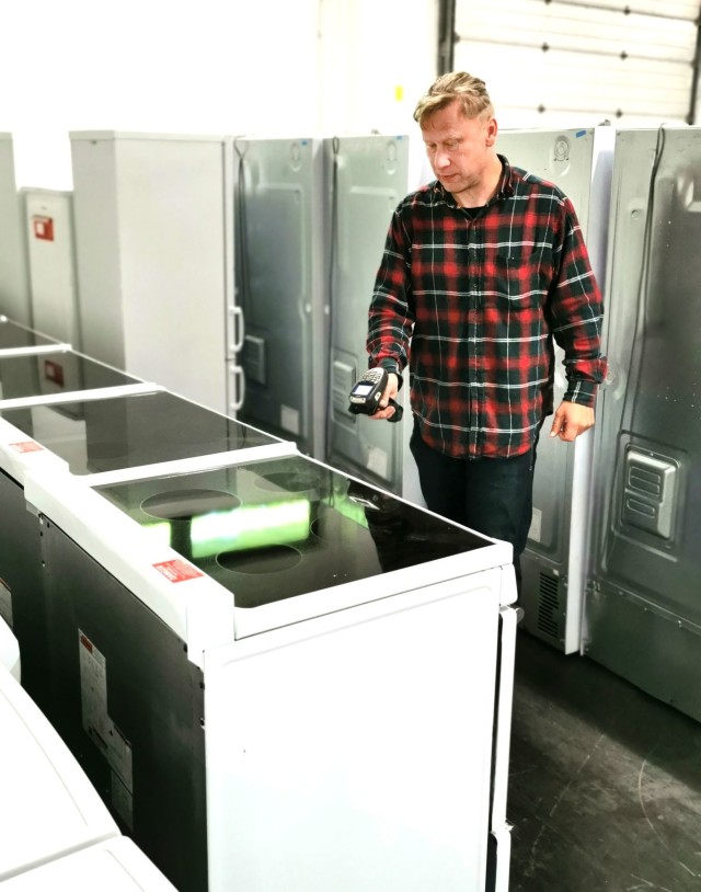 Kristjan Poellu, Baumholder Military Community Furnishings Management Office manager, check on some inventory in the warehouse. The BMC FMO warehouse holds between 8, 000 - 12,000 pieces of furniture at any one time. 
(Photo by Sascha Winter)