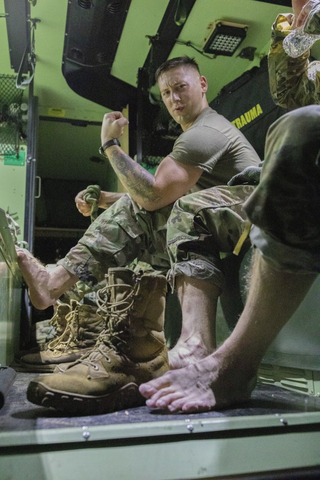 Staff Sgt. Benjamin Latham, a U.S. Reserve combat engineer, representing the 108th Training Command (Initial Entry Training), gives a celebratory flex after completing the 12-mile ruck march during the 2020 U.S. Army Reserve Best Warrior...