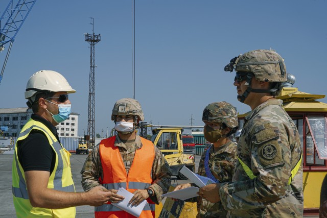 U.S. Army 1st Lt. Alex McCurry (left), Capt. Meghan Taitano (middle) and 1st Lt. Aaron Noggle (far right), assigned to the 4th Squadron, 2d Cavalry Regiment, speak with a contractor (far left) during port operations for the Noble Partner 20 exercise in Poti, Georgia, Sept. 4, 2020. Exercise Noble Partner is designed to enhance regional partnerships and increase U.S. force readiness and interoperability in a realistic, multinational training environment. The exercise allows participants to conduct situational training exercises, live-fire exercises and combined mechanized maneuvers. The 4th Squadron, 2d Cavalry Regiment (Sabers) will lead the exercise for 2d Cavalry Regiment.