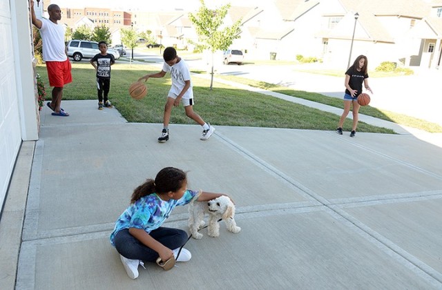 Sgt. Maj. C.J. Evans, Operations Group PLEX, Mission Command Training Program, his 7-year-old son Justice Evans, and 7-year-old neighbor Jo'Lanie Da Costa with her puppy Cooper watch 11-year-old Jaeden Evans and 13-year-old Annabel Gardea shoot...