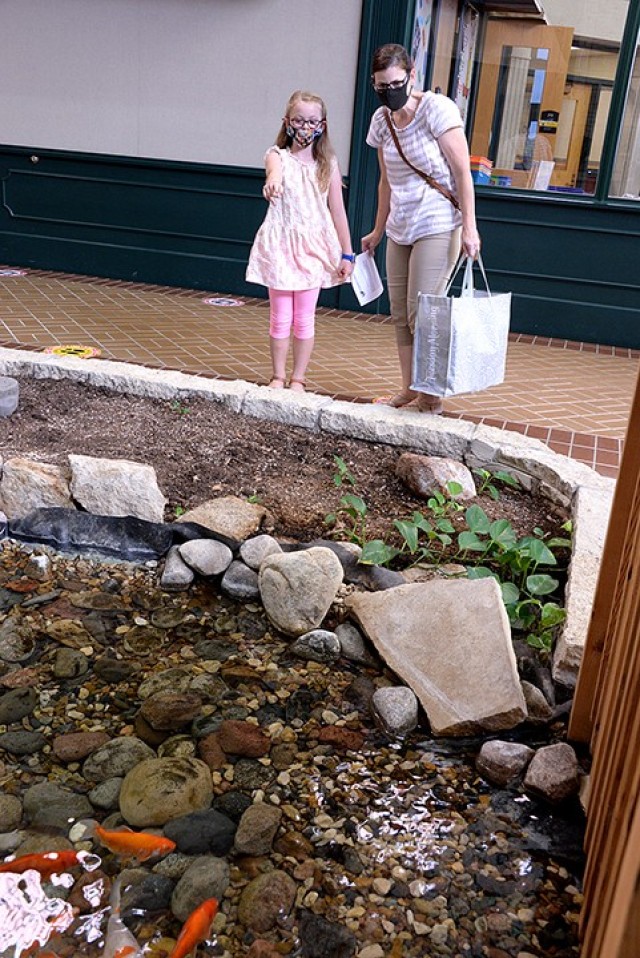 Eight-year-old Ainsley Johnson points out a turtle to her mother, Anne Johnson, as they pass the pond on their way to Ainsley's third-grade classroom Sept. 3 at Eisenhower Elementary School. Unified School District 207 students and their parents...