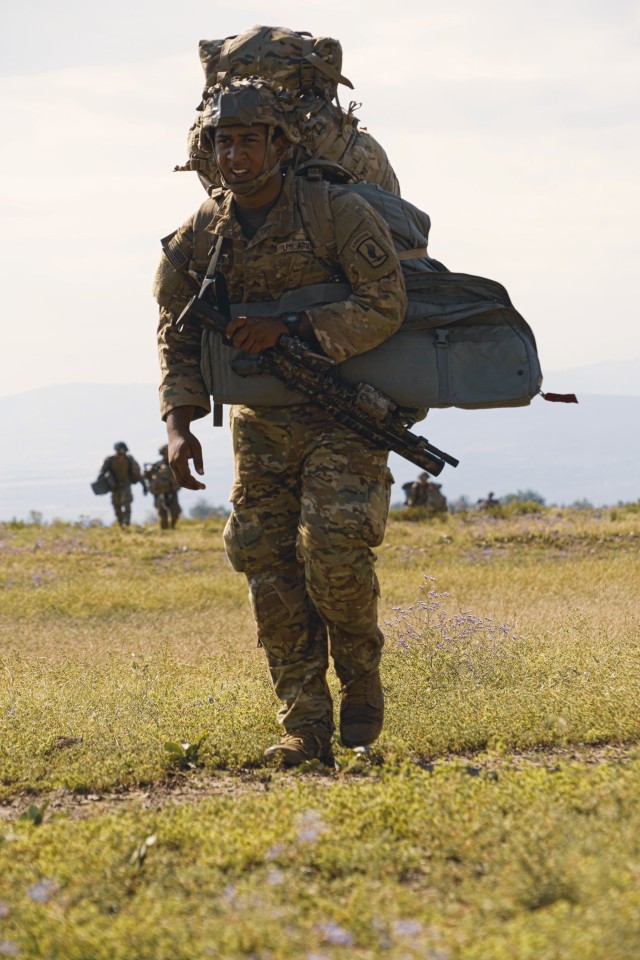 Cpl. Diante Strothers, a U.S. paratrooper assigned to the 173rd Airborne Brigade, moves to his assembly point after landing at the drop zone during Noble Partner 20 at Vaziani Training Area, Georgia, Sept. 1, 2020. Exercise Noble Partner is designed to enhance regional partnerships and increase U.S. force readiness and interoperability in a realistic; multinational training environment. The exercise allows participants to conduct airborne operations, situational training exercises; live-fire exercises and combined mechanized maneuvers.