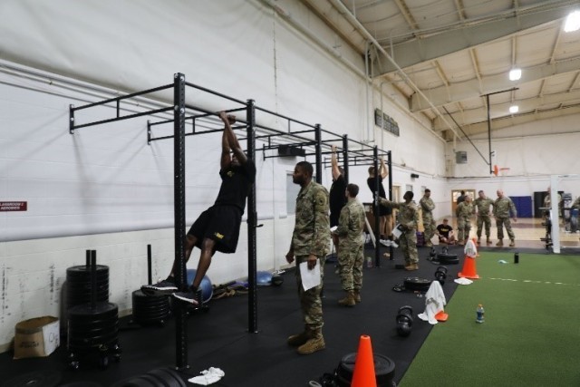 Three soldiers and their graders get ready for the knee-tuck portion of the Army Combat Fitness Test.  The ACFT was held Aug. 28 during phase two of the 2020 Region V Best Warrior Competition at Camp Robinson, Ark.