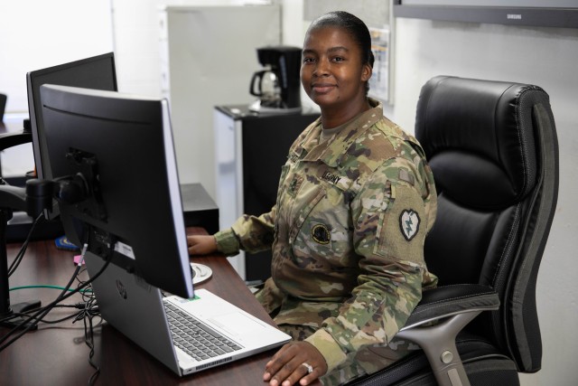 Army Sgt. 1st Class Rachelle White, a senior facilitator at the Noncommissioned Officer Academy Hawaii (NCOA), poses for a photograph at her desk at the NCOA in Mililani, Hawaii, Aug. 20, 2020. White works from her computer as the NCOA has moved to primarily virtual learning due to COVID-19 restrictions. 