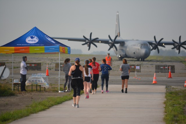 CHIÈVRES, Belgium – Runners see a C-130 land at Chievres Air Base. At three of its locations in two of its host nations, U.S. Army Garrison Benelux observed the 19th anniversary of 9/11 with a “We Remember” event and a run and walk. The...