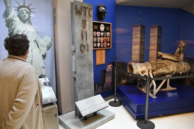 Mary Sherman, a Fort Drum retiree and Watertown resident, looks at the 9/11 artifacts inside Clark Hall after the annual 9/11 Remembrance Ceremony on Sept. 11. (Photo by Mike Strasser, Fort Drum Garrison Public Affairs)