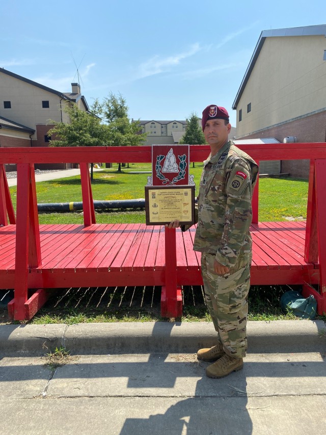 Sgt. 1st Class Nicholas Candelaria, an operations sergeant assigned to A Company, 37th Brigade Engineer Battalion, 2nd Brigade Combat Team, 82nd Airborne Division, poses for a photo holding a plaque after graduating from the U.S. Army Sapper Leader Course as earning the Distinguished Leadership Award on August 27, 2020 at Fort Leonard Wood, Missouri.