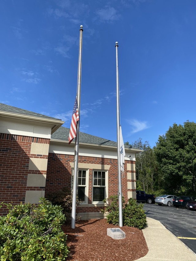 Flags are raised at half-staff at the Ayer police station in Ayer, Mass. Sept. 11, 2020. Mass. Governor Charlie Baker ordered that the United States and the Commonwealth of Massachusetts flags be raised at half-staff throughout the Commonwealth in honor of the victims of 9/11. (U.S Army Photo taken by Spc. Christie Ann Belfort.)