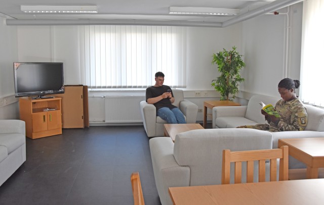 WIESBADEN, Germany - Soldiers relax on couches in a newly-renovated day room in barracks building 1206 Sept. 11 on Clay Kaserne. U.S. Army Garrison Wiesbaden has been working to renovate areas of the barracks and give Soldiers more space.