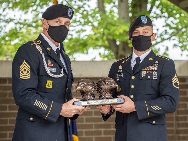 Staff Sgt. Benjamin L. Latham (right), a U.S. Army Reserve Sapper-qualified combat engineer from Joliet, Illinois, representing the 95th Training Division (Initial Entry Training), 108th Training Command (Initial Entry Training), receives the Army Commendation Medal and a trophy from Command Sgt. Maj. Andrew Lombardo, U.S. Army Reserve command sergeant major, for winning Noncommissioned Officer of the Year in the 2020 U.S. Army Reserve Best Warrior Competition at Fort McCoy, Wisconsin, Sept. 10. More than 40 Soldiers from across the nation traveled to compete in this year’s Best Warrior, hosted from Sept. 4-10, 2020. The 2020 BWC is an annual competition that brings in the best Soldiers across the U.S. Army Reserve to earn the title of “Best Warrior” among their peers. Competitors are evaluated on their individual ability to adapt and overcome challenging scenarios and battle-focused events, which test their technical and tactical abilities under stress and extreme fatigue. (U.S. Army Reserve photo by Master 