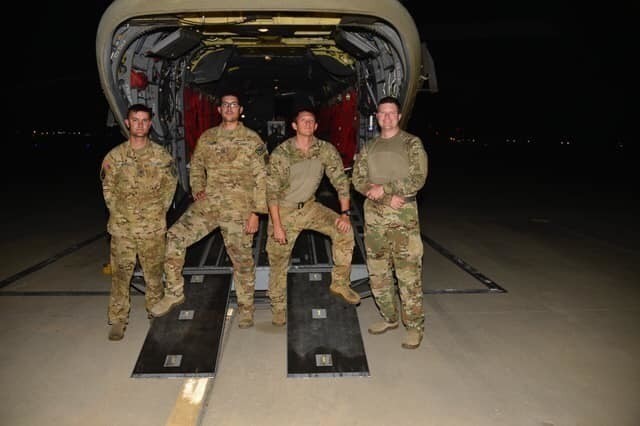 The California Army National Guard CH-47 Chinook helicopter crew from the 40th Combat Aviation Brigade that flew more than 200 people to safety from the Creek Fire poses for a picture on Sept. 5, 2020. From left, flight engineer Sgt. Cameron Powell, flight engineer Sgt. George Esquivel, pilot Chief Warrant Officer 2 Brady Hlebain, and pilot-in-command Chief Warrant Officer 5 Joseph Rosamond.