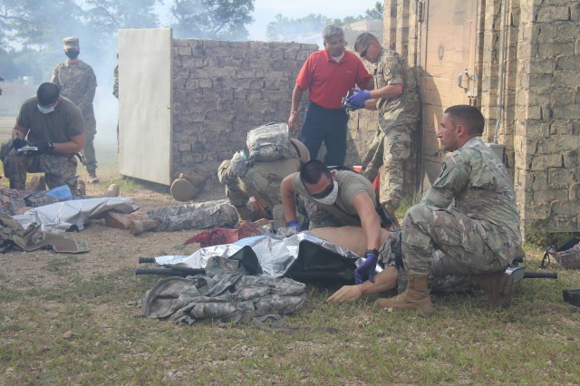 Members of the 807th Medical Command of Salt Lake City, Utah, work on medical mannequins while Medical Simulation Training Center (MSTC) staff members observe during a training scenario during the unit's 68W (combat medic specialist) refresher...