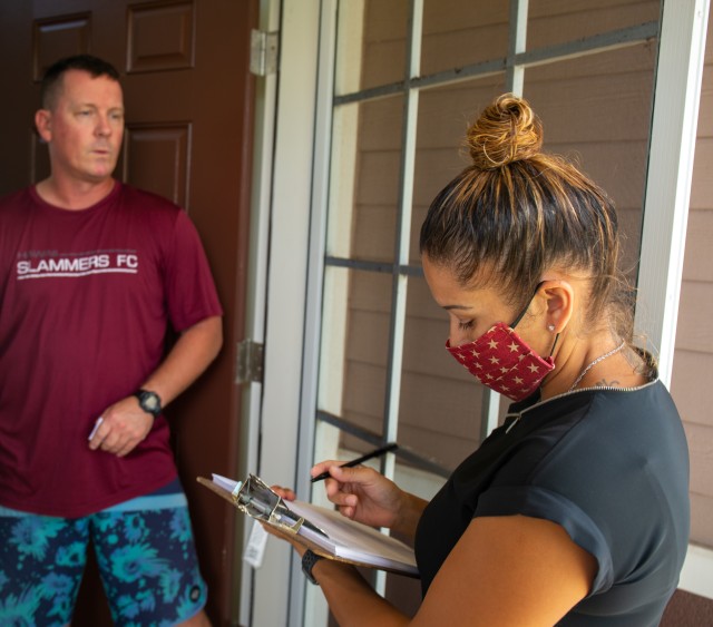 Sergeant First Class Sabrina Nededog speaks with a Soldier about his move, ensuring he has not had any issues with the transportation service provider (TSP).