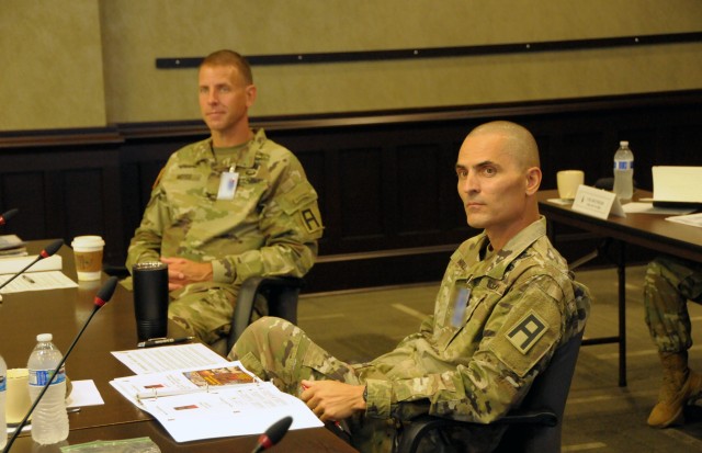 Col. James Moyes (left) and Command Sgt. Maj. Darrell Walls, the First Army Division West commander and command sergeant major, respectively, take in lessons during the First Army Command Team Certification in First Army headquarters on Rock Island Arsenal, Ill.