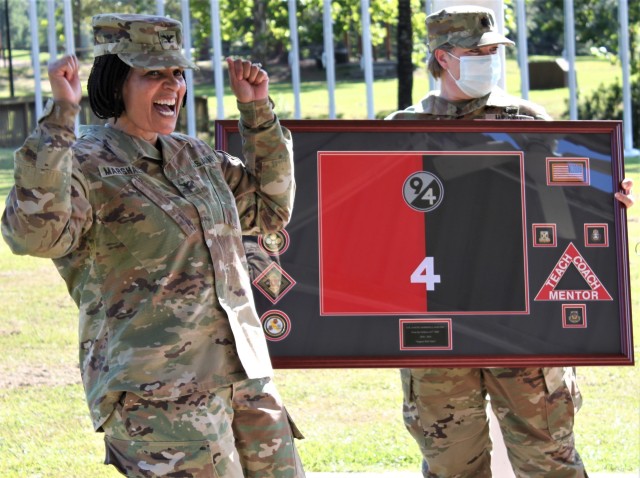 Col. Janene Marshall-Gatling, outgoing 4th Brigade (Personnel Services) commander (left) is all smiles upon receiving a farewell gift from the Soldiers of  the 4th Brigade (PS) during the unit’s change of command ceremony. The ceremony was held...