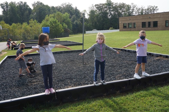 Jasmyn Chase, left,  Matilda Bumann, and Simon Wulbur, first grade students, play on the playground during a recent recess time at Baranti Elementary School. Grade levels are encouraged to alternate times to use the playground for recess....