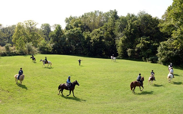 Riders maneuver around Eight Easy Lessons to Foxhunting instructor retired Lt. Col. Simon Gardner, center, as he has them practice getting off the trail, not stepping on crops and other things they will need to know how to do correctly and quickly...