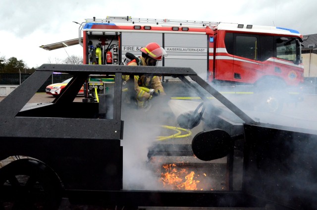A firefighter from the U.S. Army Garrison Rheinland-Pfalz trains to put out a car fire using the garrison's new Hose Line Training Aid System. Training chiefs can switch out different training aids to simulate fires with propane tanks, barbecue...