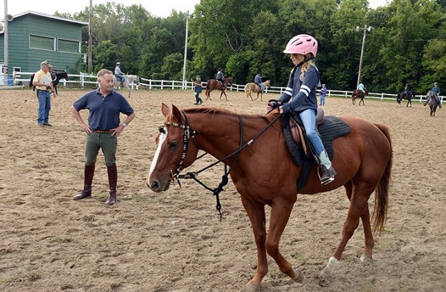 Eight Easy Lessons to Foxhunting instructor retired Lt. Col. Simon Gardner watches 9-year-old Emma Kate Sampson ride Tammy Hane's quarter horse Little Joe as riders new or returning to foxhunting walk their horses around the arena for instructors...