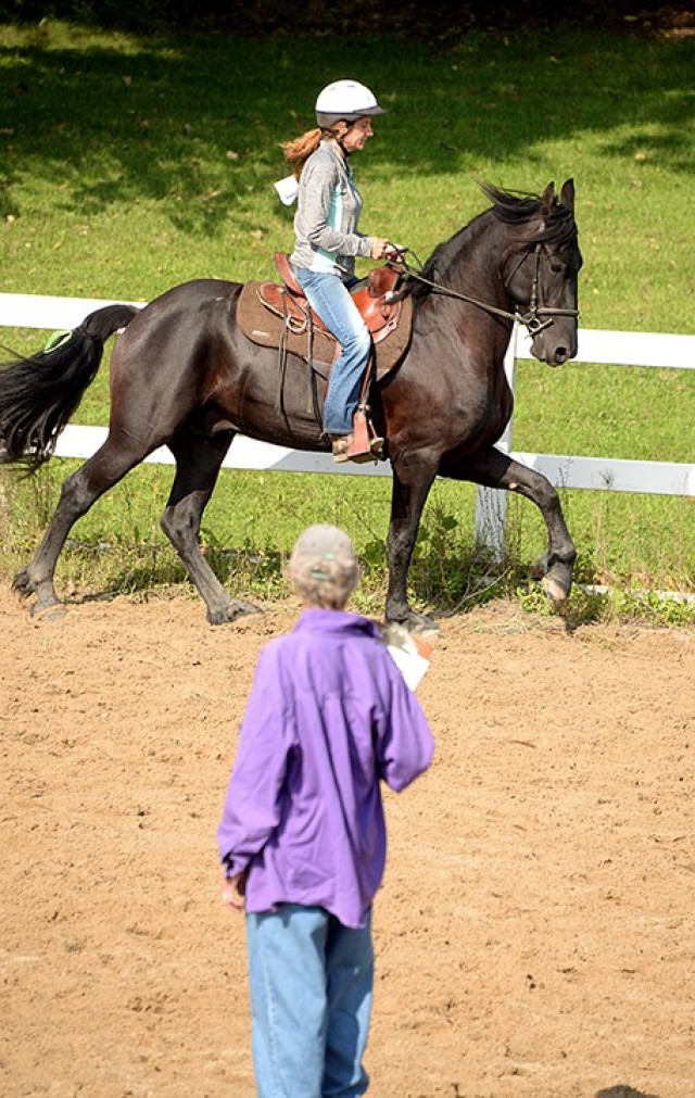 Cecelia Trabert critiques the skill levels of riders and their horses, including Heather Williams and her Friesian Arie, to help determine where they should start out in the field during the Fort Leavenworth Hunt's Eight Easy Lessons to Foxhunting...