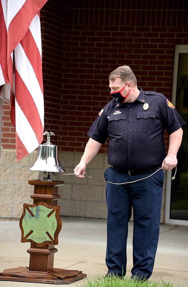 Fire Capt. Richard Baggett rings the ceremonial fire bell in three series of five rings — known as the "Last Call," a tradition of honor and respect for fallen firefighters — to remember first responders who lost their lives in service on Sept. 11, 2001, during a remembrance ceremony Sept. 11 at Fire Station No. 2. Photo by Prudence Siebert/Fort Leavenworth Lamp