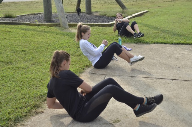 Kelsey Otten, R2 team member, Casey Fallin, Bastogne spouse, and Becky Farmer, R2 Performance Center Manager, participate in a group working out during the five-week long R2 Bastogne Spouse Boot Camp, Sept 15, at the R2 Performance Center, 6997 A...