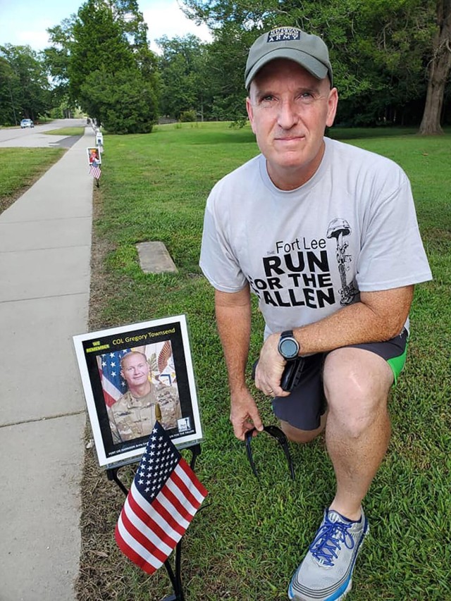 Maj. Gen. Rodney D. Fogg, U.S. Army Combined Arms Support Command and Fort Lee commanding general, poses next to a picture of Col. Greg Townsend, former 23rd Quartermaster Brigade commander, Saturday during the virtual Run for the Fallen 5K Run/Walk. RFTF is an annual event honoring those who died while serving in uniform. Townsend died April 2019 after helping a stranded motorist on Route 460.