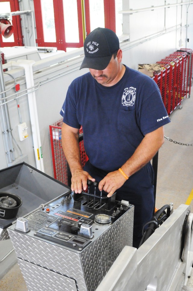 Capt. Jesse Jackson, lead fire fighter and remote ladder truck operator at the scene of Fort Polk's most recent fire, shows off the remote knobs and levers he uses to control the ladder and nozzle on the Fort Polk's ladder truck.