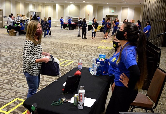 Maria Duncan, Fort Leavenworth Spouses Club Running Club subclub co-leader, talks with Shannon Beery, FLSC parliamentarian, and Sara Pieluszczak, FLSC treasurer, about a "selfie" scavenger hunt for members designed to help familiarize them with...