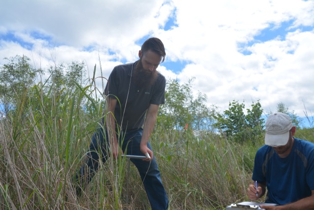 Aaron McFarlane, St. Paul District biologist, takes a soil sample at a constructed island in Pool 8, near LaCrosse, Wisconsin, July 22.