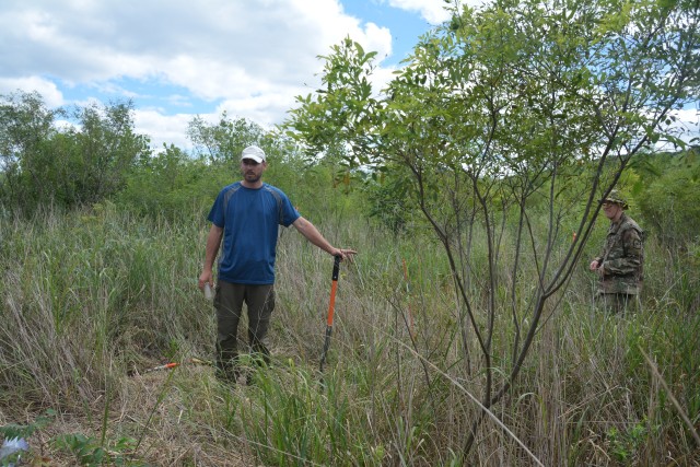 Eric Hanson, St. Paul District ecologist, takes a soil sample at a constructed island in Pool 8, near La Crosse, Wisconsin, July 22.