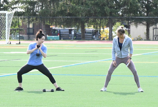 Traci Bickelhaupt (right) guides a group through an outdoor session of the Functional Fitness class, scheduled twice weekly at Magrath Sports Complex. This is one of three different classes offered through Fort Drum Family and Morale, Welfare and...