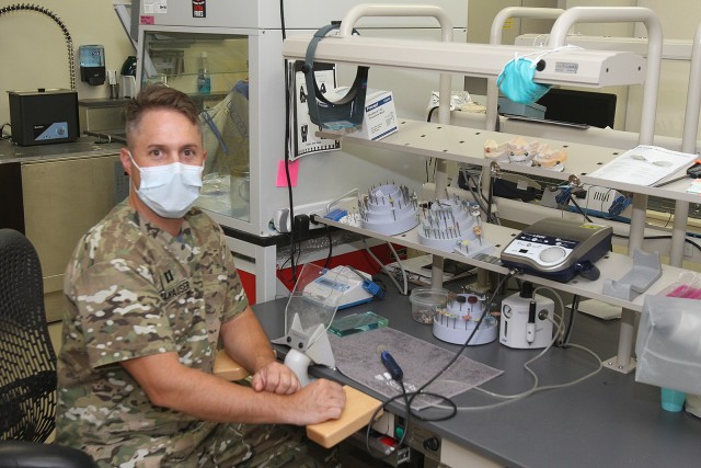 Capt. Preston Melhauser sits at a lab station in Cowan Dental Clinic that provides training space for students in the Comanche Advanced Education in General Dentistry program. Dentists also use it to improve the natural appearance of CAD-CAM...