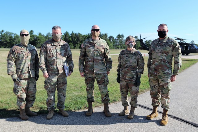 Several Army leaders participated in a familiarization flight Aug. 4, 2020, over Fort McCoy in a Wisconsin National Guard UH-60 Black Hawk helicopter. Pictured are (from left): Brig. Gen. John C. Hafley, 88th Readiness Division deputy commanding general; Maj. Gen. Darrell C. Guthrie, 88th Readiness Division commanding general; Maj. Gen. Rodney L. Faulk, First Army deputy commanding general (support); Brig. Gen. Stacy M. Babcock, 86th Training Division commanding general; and Col. Michael D. Poss, Fort McCoy Garrison commander. The leaders learned more about the training areas of the installation and observed troops training in the field. (U.S. Army Photo by Scott T. Sturkol, Public Affairs Office, Fort McCoy, Wis.)