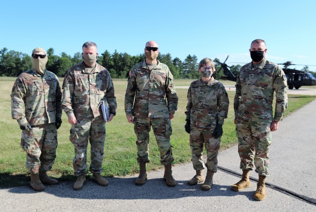 Several Army leaders participated in a familiarization flight Aug. 4, 2020, over Fort McCoy in a Wisconsin National Guard UH-60 Black Hawk helicopter. Pictured are (from left): Brig. Gen. John C. Hafley, 88th Readiness Division deputy commanding general; Maj. Gen. Darrell C. Guthrie, 88th Readiness Division commanding general; Maj. Gen. Rodney L. Faulk, First Army deputy commanding general (support); Brig. Gen. Stacy M. Babcock, 86th Training Division commanding general; and Col. Michael D. Poss, Fort McCoy Garrison commander. The leaders learned more about the training areas of the installation and observed troops training in the field. (U.S. Army Photo by Scott T. Sturkol, Public Affairs Office, Fort McCoy, Wis.)