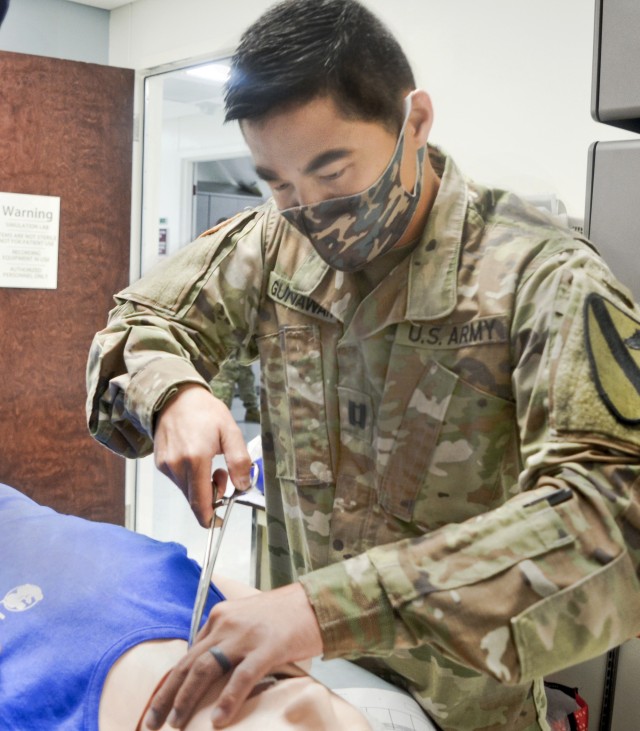 Capt. Christopher Gunawan, pediatrician, practices a cricothyroidotomy during Individual Critical Task List training at the CRDAMC simulation lab August 21. The realistic, standards-based readiness training allows CRDAMC medical personnel working in garrison to maintain and exceed proficiency in combat casualty care skills needed to care for wounded service members while deployed overseas.
