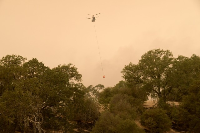 The Dolan Fire Incident Management team has been using the post’s Tusi heliport as a helitack base to stage up to 10 helicopters that provide bucket drops to all areas of the fire. They are also using other areas on post to provide a rest...