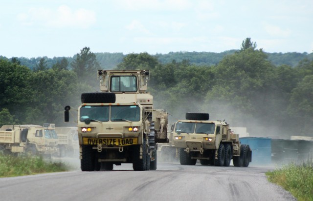 Soldiers with the 123rd Engineer Battalion of the Illinois National Guard move equipment in a convoy Aug. 6, 2020, on North Post at Fort McCoy, Wis. The battalion’s Soldiers were among approximately 4,000 service members training at Fort McCoy during the first week of August 2020. Transient troop training like this resumed at Fort McCoy in July 2020 after being stopped for several months because of the COVID-19 pandemic response. Over months of planning, however, Fort McCoy training officials were able to reopen the training with COVID-19 safety measures built in. Fort McCoy’s motto is to be the “Total Force Training Center.” (U.S. Army Photo by Scott T. Sturkol, Public Affairs Office, Fort McCoy, Wis.)