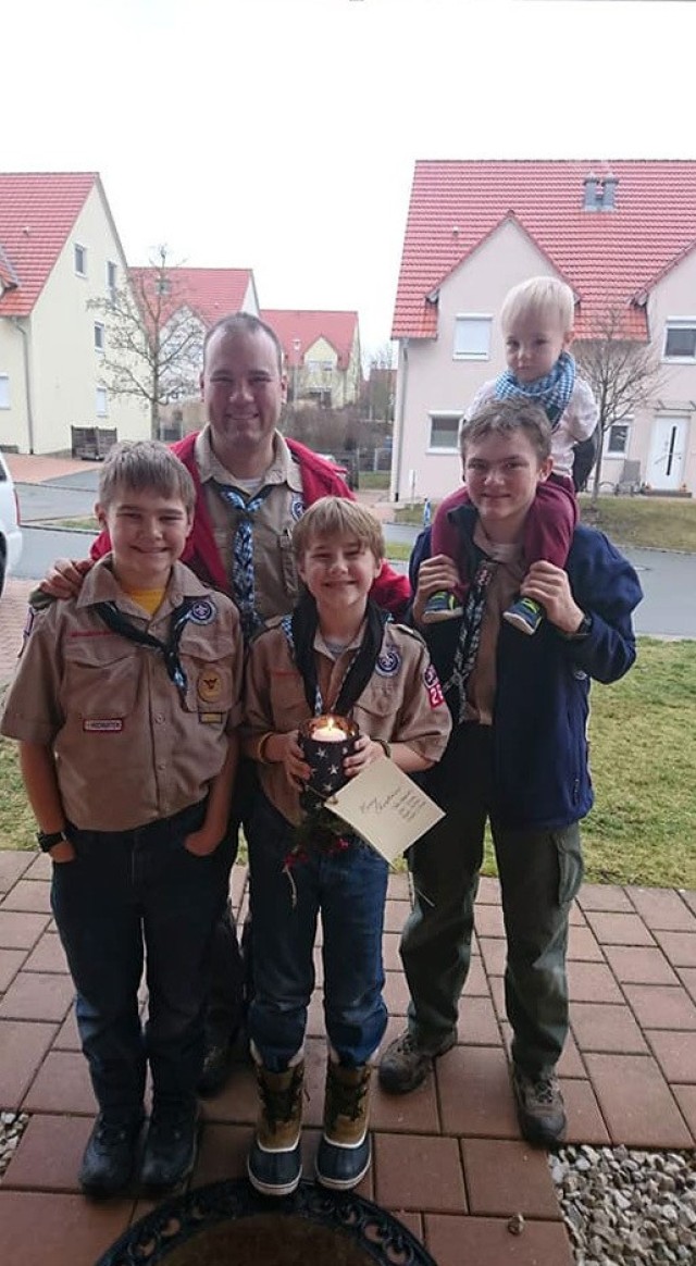 Lt. Col. Joel Gleason, commander of U.S. Army Garrison Okinawa and Scoutmaster of Boy Scout Troop 101 in Okinawa, with his sons Kipp, Colton, Cooper and Finn, prepare to bring a candle lit with the Peace Light to a neighborhood chaplain in...