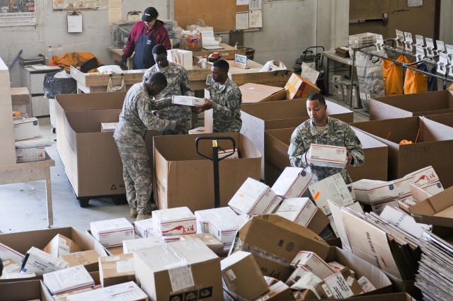 (From left to right) Spc. Mark Bickley from Akron, Ohio; Pfc. Javaris Cole from Greenville, Miss.; Pfc. Marctavious Roach of Rutherford, Tenn.; and Spc. Erik Maldonado from Columbus, Ga., sort mail at the Joint Military Mail Terminal, 1st Sustainment Command (Theater), Camp Arifjan, Kuwait, Dec. 22. All mail addressed to troops in Southwest Asia passes through the JMMT so it can be scanned and sorted before being distributed throughout the theater of operations. (U.S. Army Photo by Sgt. 1st Class Joshua S. Brandenburg, 7th Mobile Public Affairs Detachment)