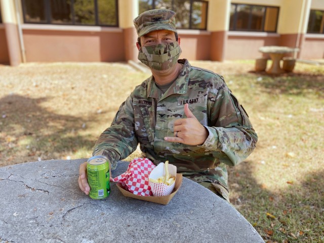 402nd AFSB commander Col. Anthony Walters enjoys his first taste of The Culinary Outpost.