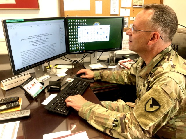 Chaplain (Lt. Col.) Craig Johnson, U.S. Army Garrison Rheinland-Pfalz command chaplain, checks over his paper, "Preaching Suicide Prevention," which he will present to the Academy of Homiletics in December. Chaplain Johnson is the first military chaplain to present a paper to the prestigious organization.